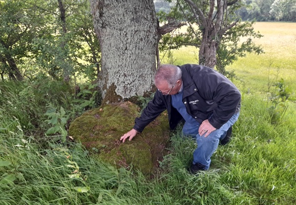 Nick Austin by the stone which he believes marks the spot where Harold was buried.