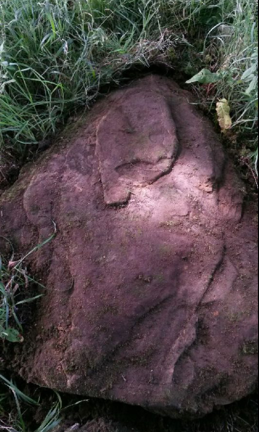 Image of the marker stone found in the centre of the Crowhurst battlefield with Latin wording being examined by experts