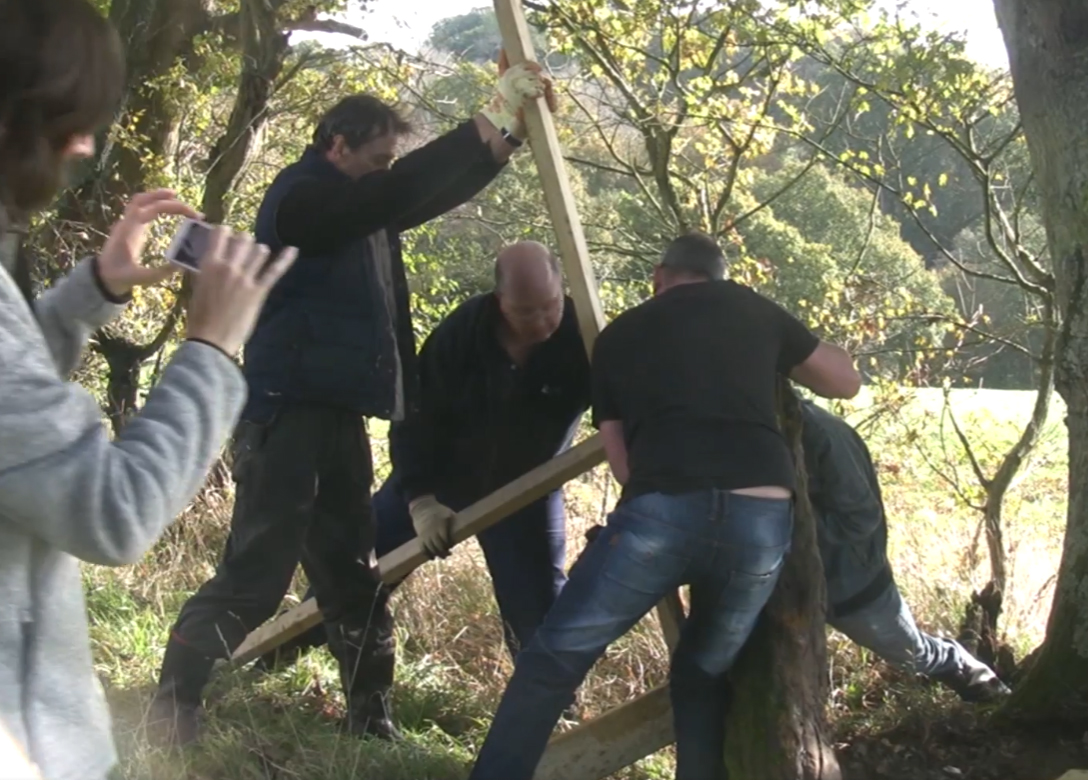 Locals assist to move the marker stone resulting in damage which could not be avoided.